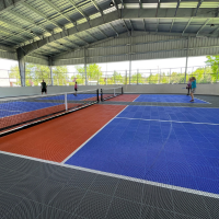Open air gymnasium with people playing pickleball