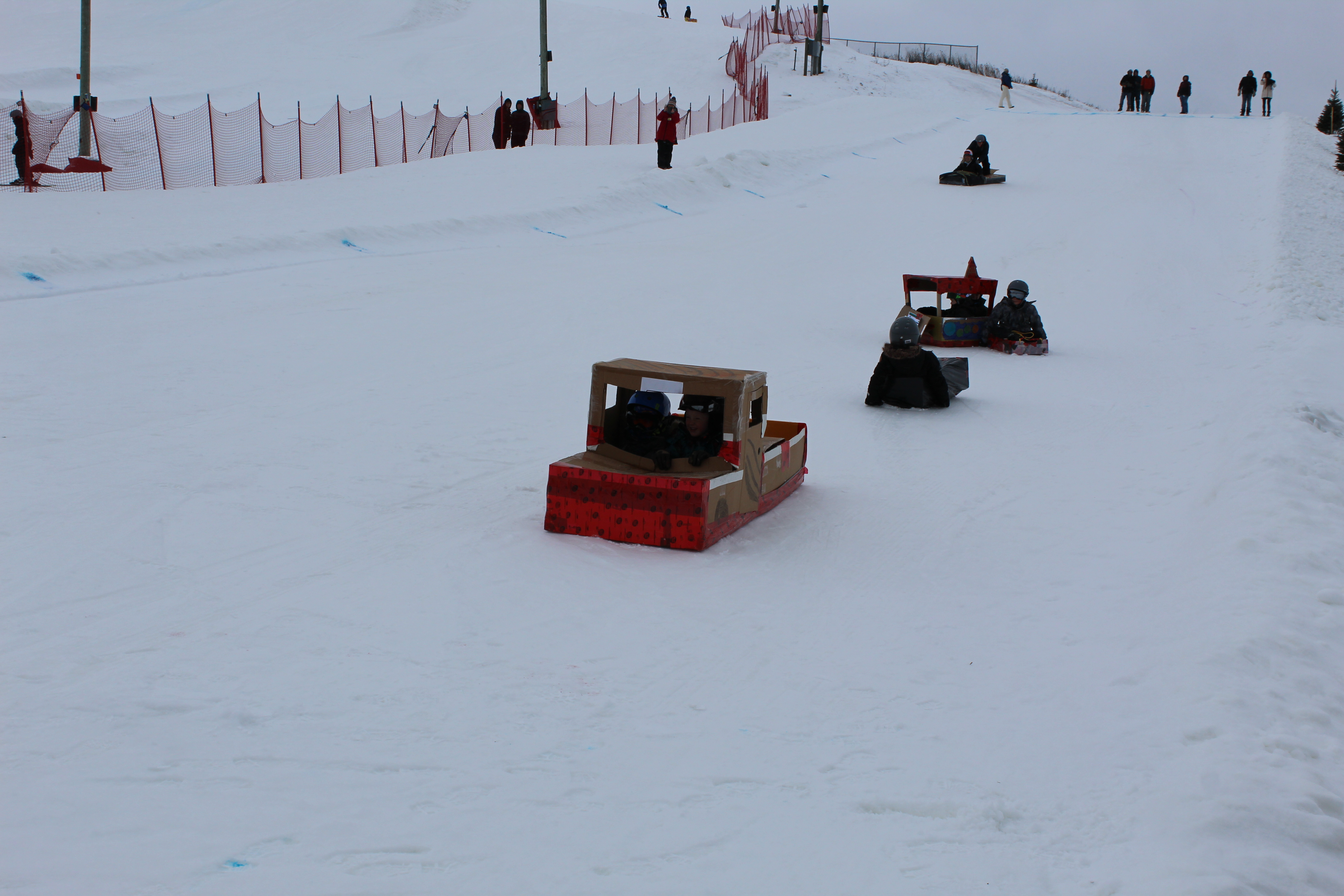 cardboard toboggans coming down the hill