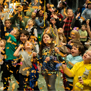 group of kids watching confetti fall 