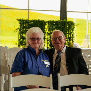 Woman and man sitting in white chairs