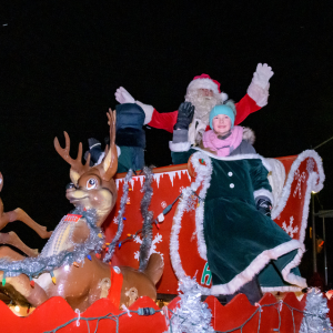Santa Claus on a sleigh with a child dressed in Victorian dress 