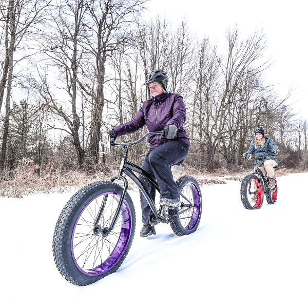 People cycling in the snow