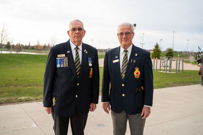 two men standing outside