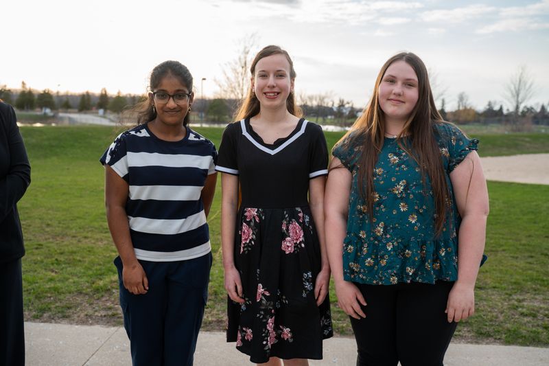 three women standing outside