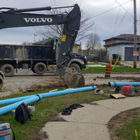 Road construction with truck and watermain under road