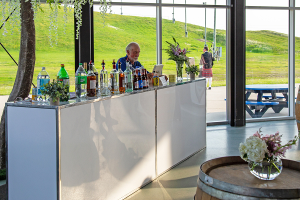 bartender at a white bar with drinks