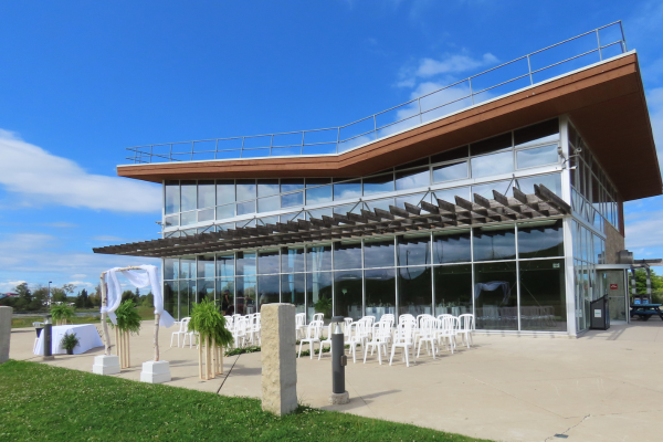 Outside of the ROC Chalet with arbor and seating for a wedding ceremony