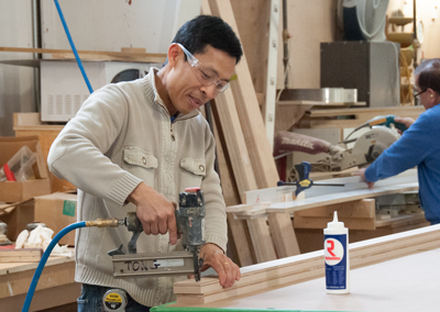 Man doing woodworking in a facility in Georgina