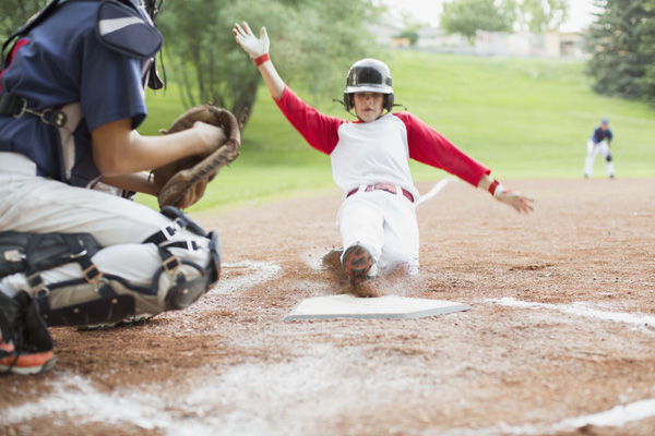 Baseball player sliding into home plate Baseball player sliding into home plate
