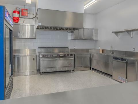 Kitchen area with fridges, stoves and counters