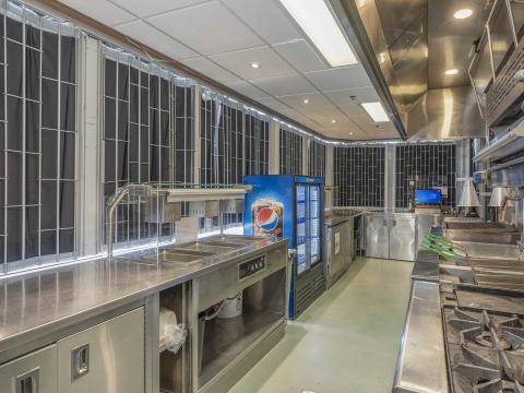 Kitchen area with fridges, freezers, stoves and counters