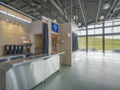 Cafeteria area with coffee machines and a small counter