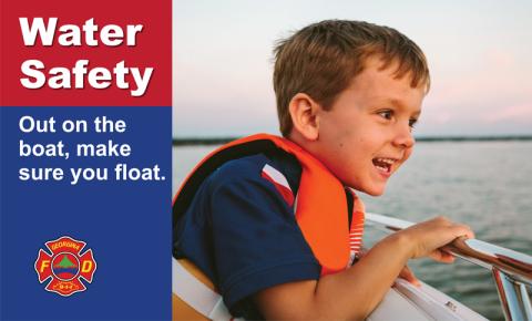 Boy in life jacket on a boat