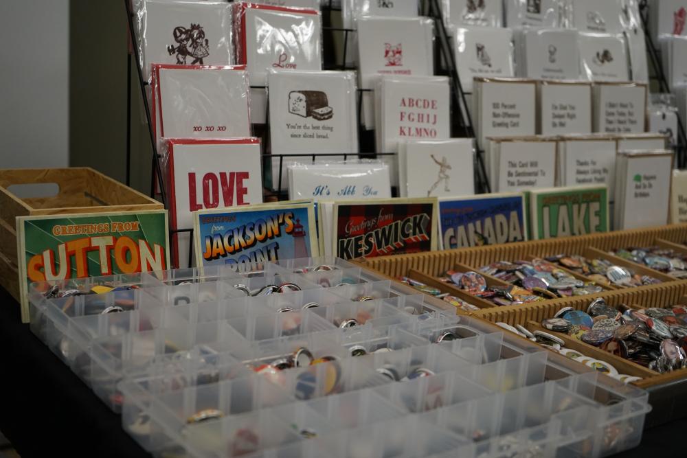 table at a fair with pins and printed items