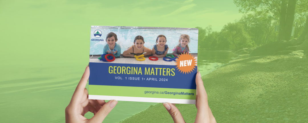 hands holding up a newsletter that says Georgina Matters