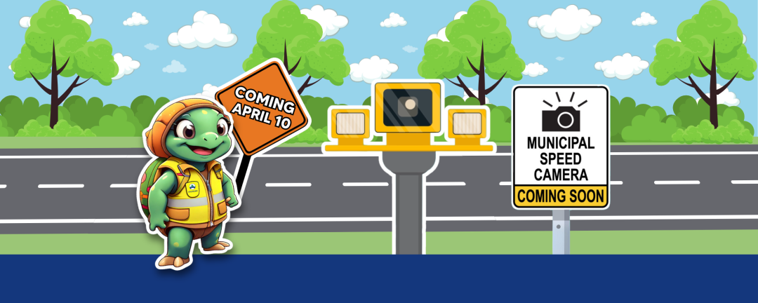 shelly holding sign saying coming April 10 beside a sign that says municipal speed camera coming soon