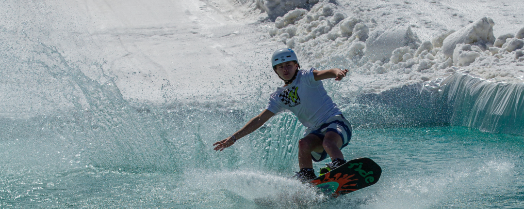 man on snowboard going across a pond of water at the ROC